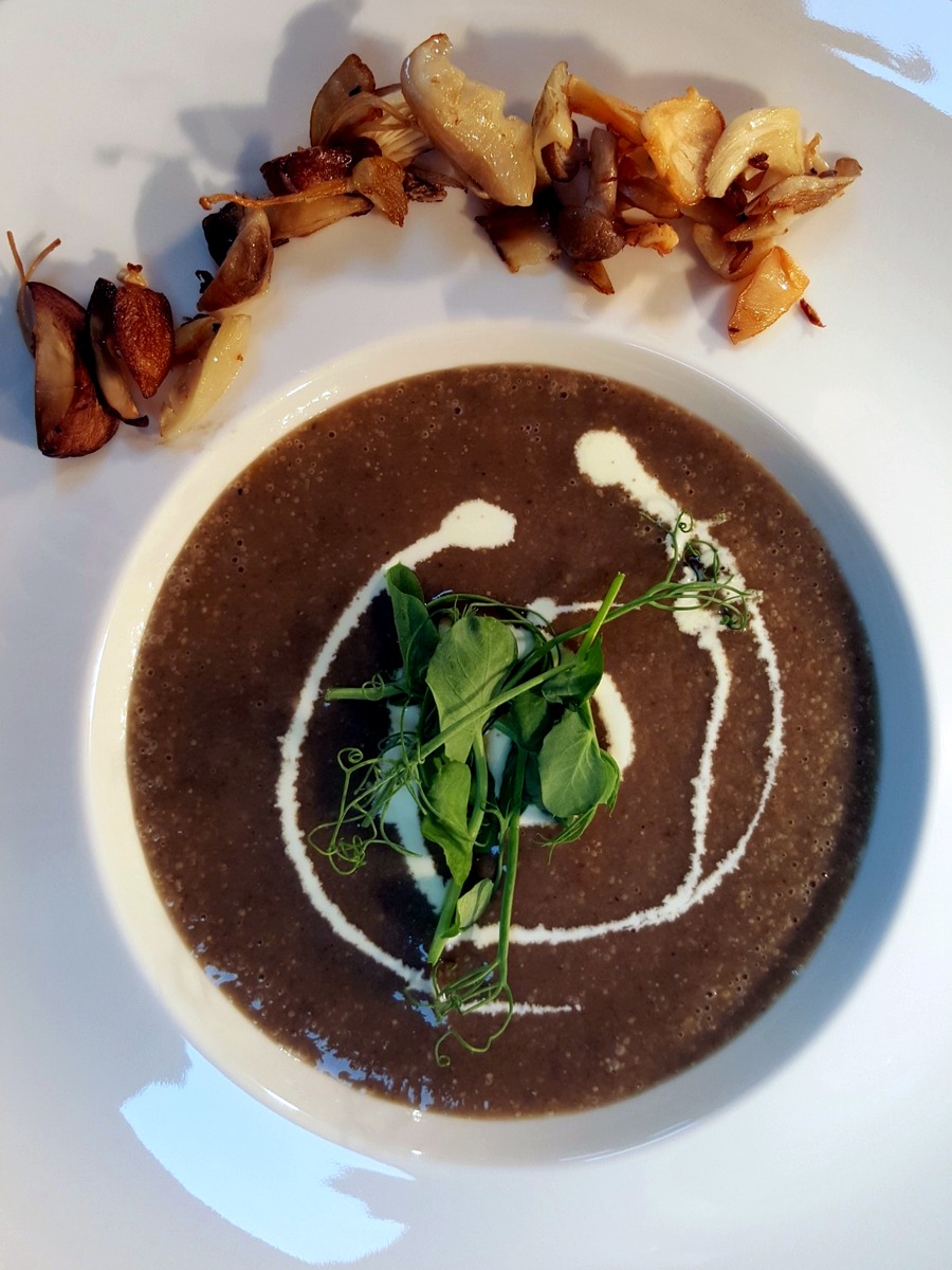 Wild mushroom soup with cream and micro herbs