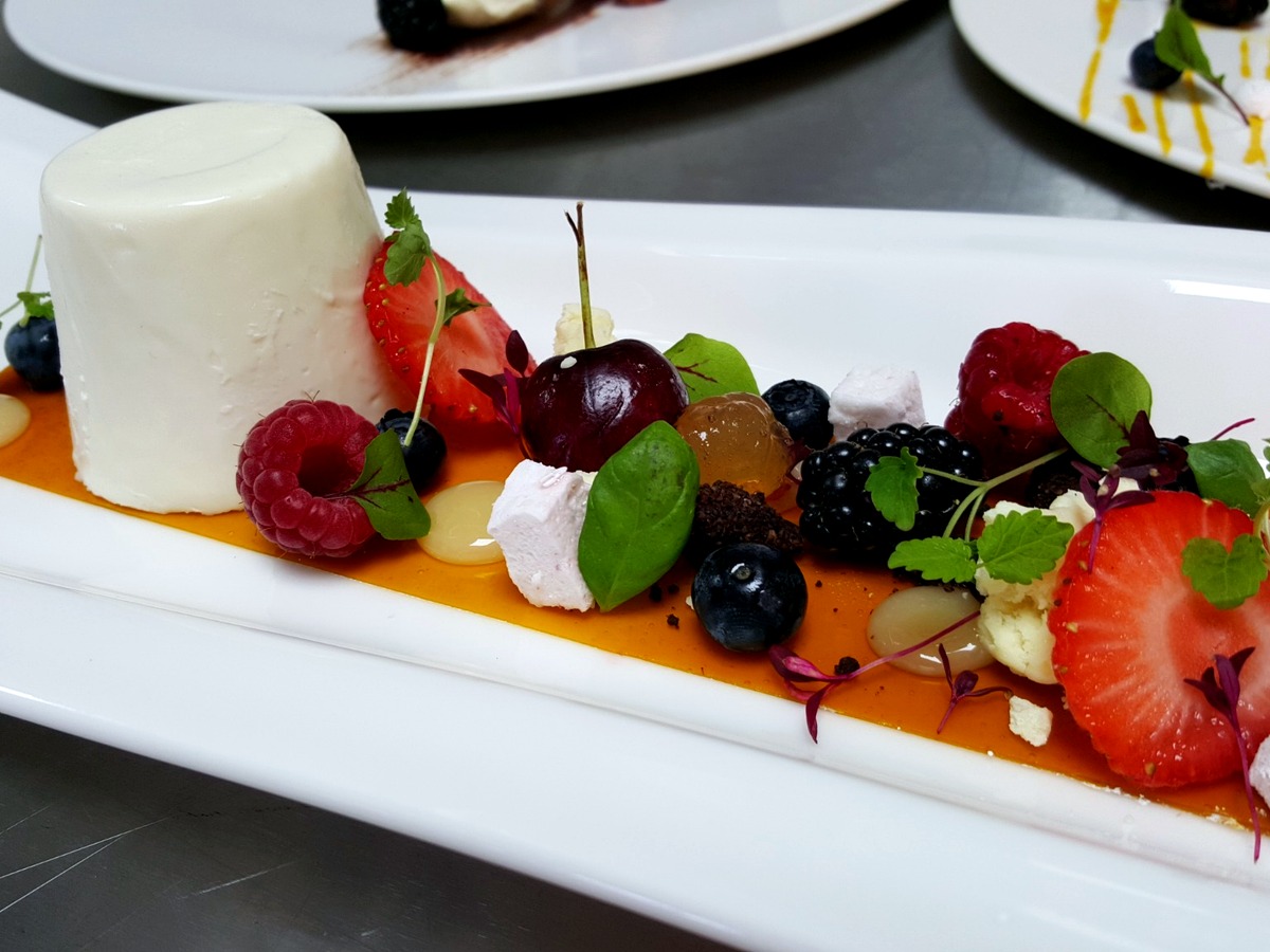 Panna cotta with fresh berries and orange coulis