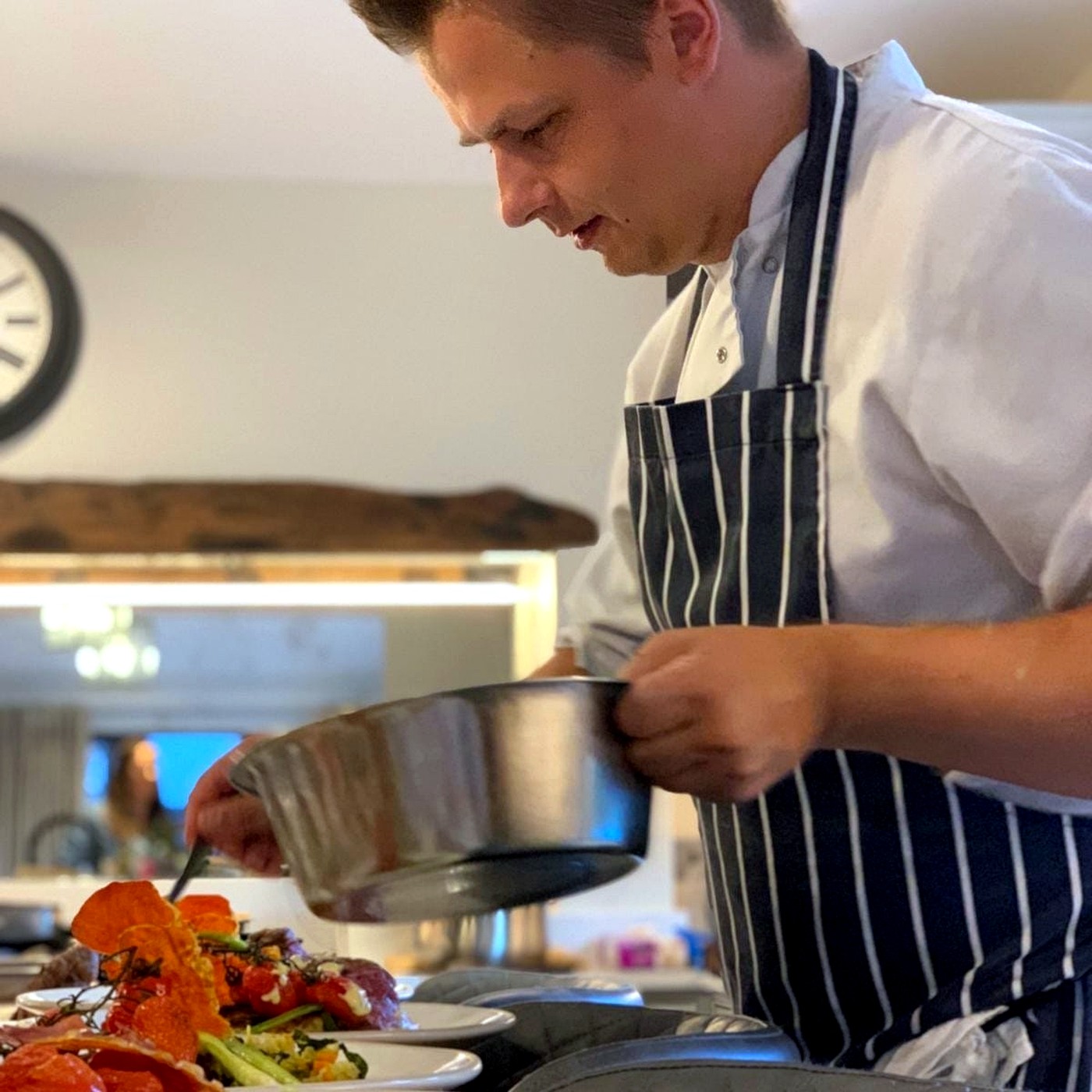 Chef Norbert plating dishes during a private dining service